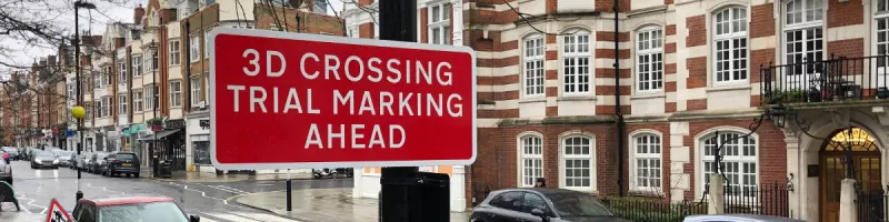A red sign reads "3D crossing trial marking ahead", which rather spoils the element of surprise. Click to enlarge