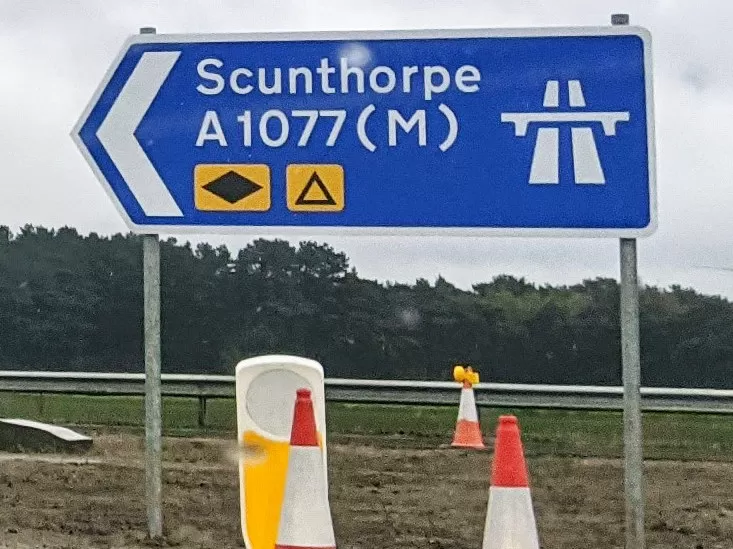 Around the roundabout, here's the only exit that's not a u-turn: Scunthorpe, A1077(M).
